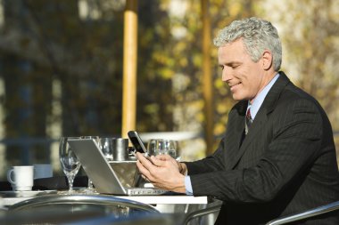 Businessman sitting outdoors. clipart