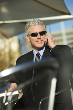 Businessman on cellphone. clipart