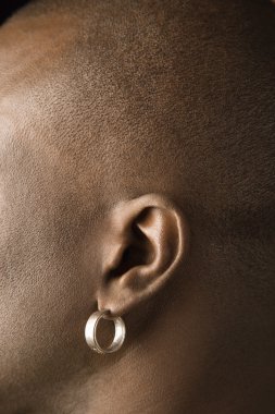 Man's ear with earring. clipart