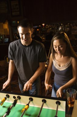 Couple playing foosball. clipart