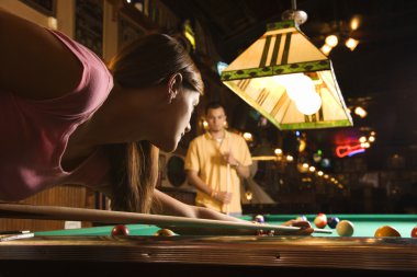 Young Woman Shooting Pool clipart