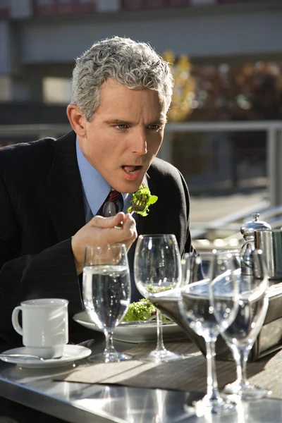 Businessman eating lunch. — Stock Photo, Image