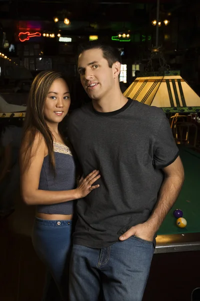 Couple by pool table. — Stock Photo, Image
