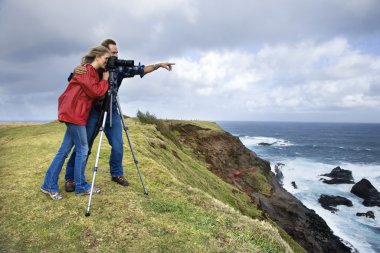 Couple using camera. clipart