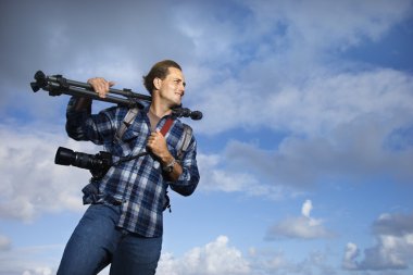 Man holding photography equipment. clipart