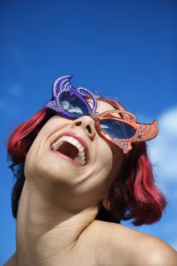 Woman wearing unique sunglasses. clipart