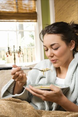 Young Woman Eating Soup clipart