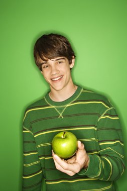 Boy holding apple. clipart