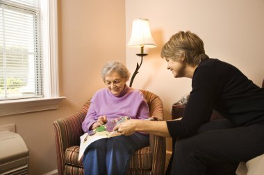 Woman Visiting Older Woman clipart