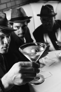 Retro men drinking martinis. clipart