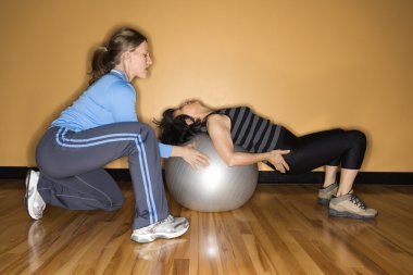 Women Using Balance Ball clipart