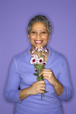 Woman holding flowers. clipart