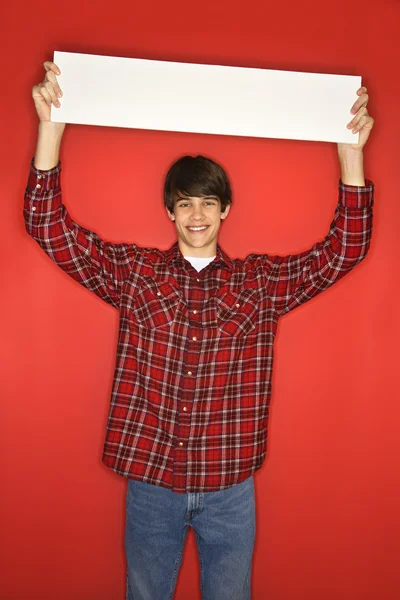 Boy holding blank sign. — Stock Photo, Image