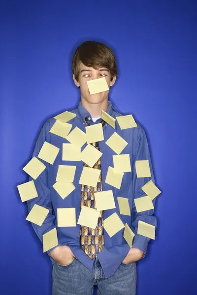 Caucasian teen boy covered with sticky notes. — Stock Photo, Image