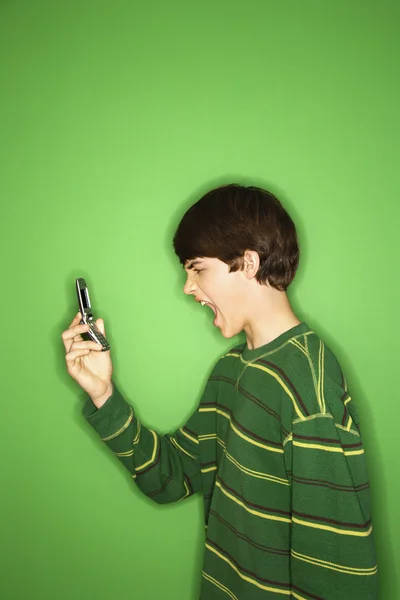 Boy yelling into phone. — Stock Photo, Image