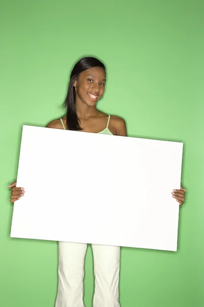 Teen girl holding blank sign. — Stock Photo, Image