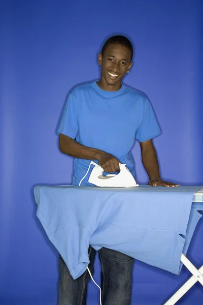 Teen boy doing chores. — Stock Photo, Image