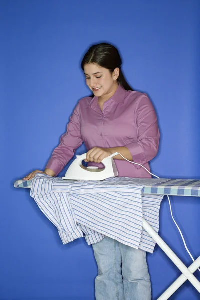 Teenage girl ironing shirt. — Stock Photo, Image