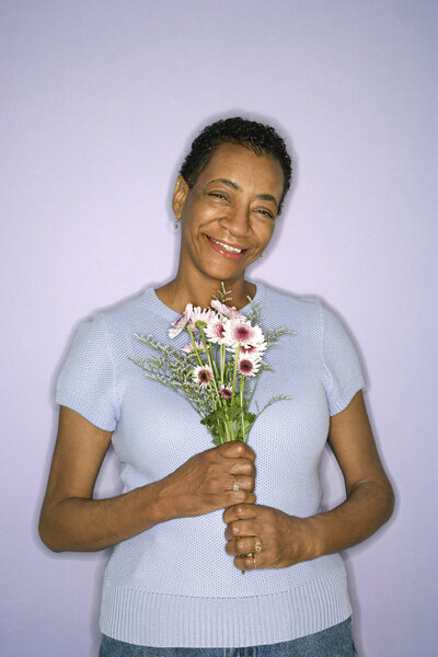 Woman holding flowers.