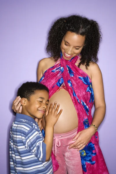 Son holding pregnant belly. — Stock Photo, Image