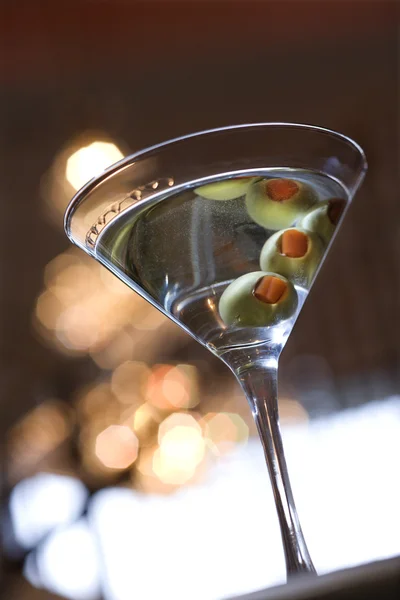 Martini met olijven weerspiegeld in top van drankje — Stockfoto
