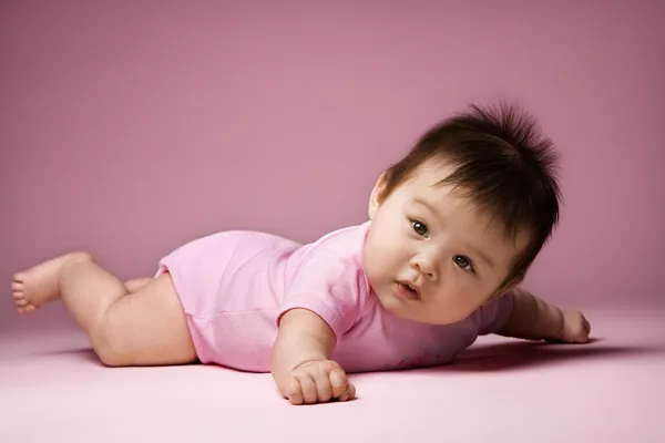 Baby lying on stomach. Royalty Free Stock Images