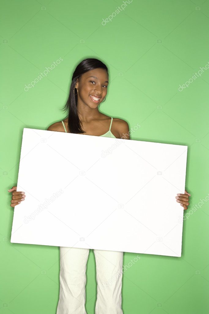 Teen girl holding blank sign.