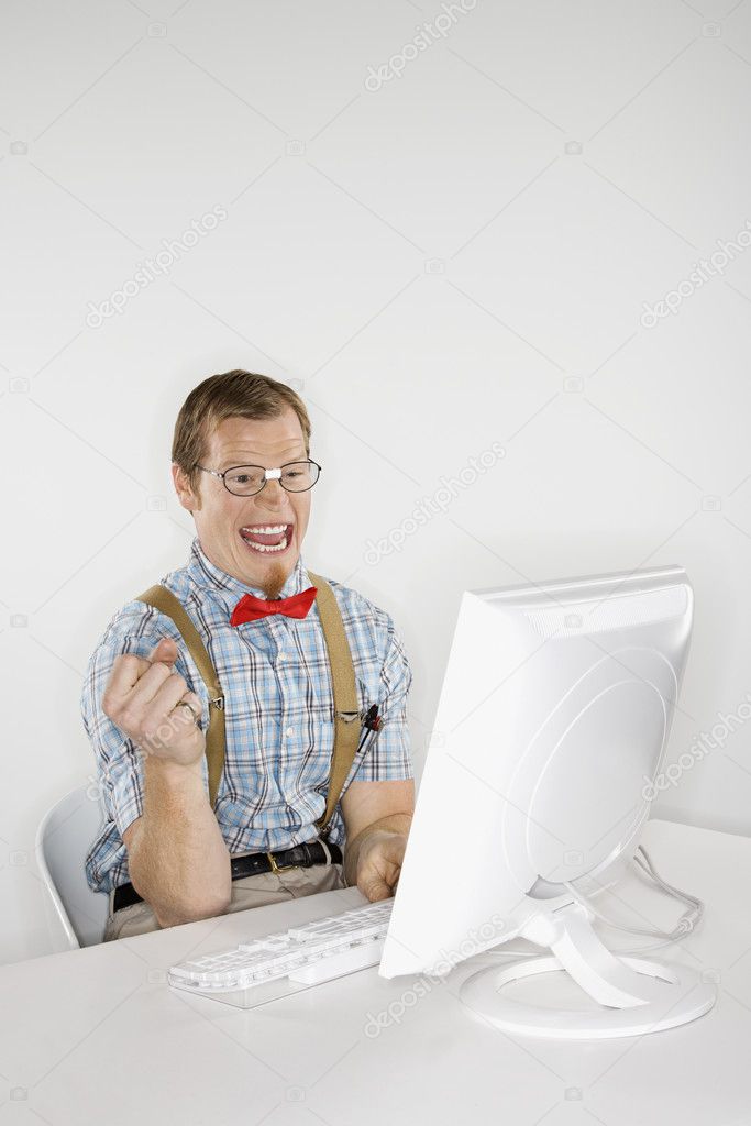 Excited man with computer.