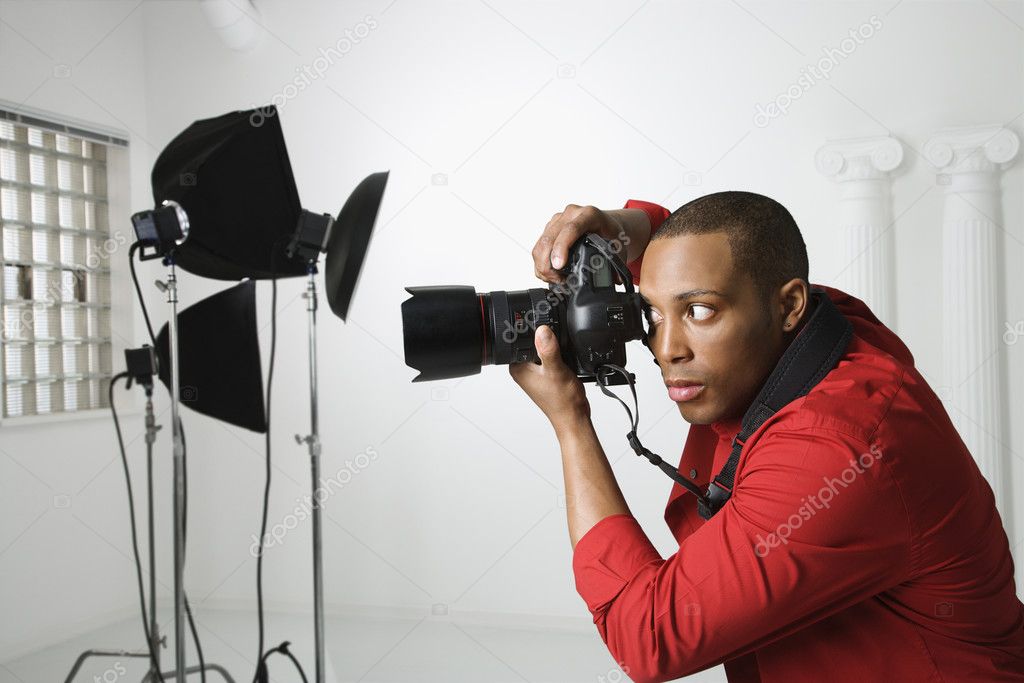 Man photographing in studio.