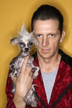 Man holding Chinese Crested dog. clipart
