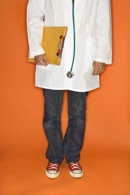 Doctor wearing jeans and sneakers. clipart