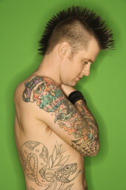 Shirtless male with tattoos. clipart