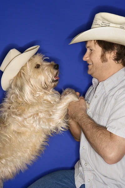 Dog and man in cowboy hats. — Stock Photo, Image
