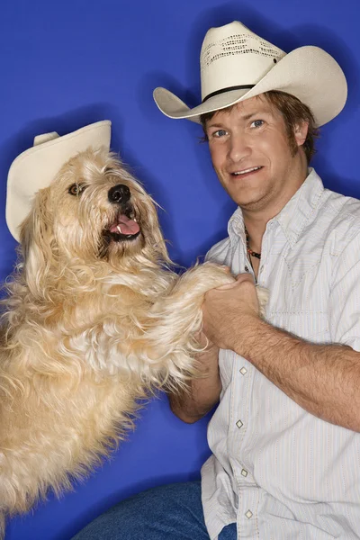 Perro y hombre en sombreros de vaquero . —  Fotos de Stock