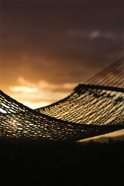 Hammock against Maui ocean sunset. clipart