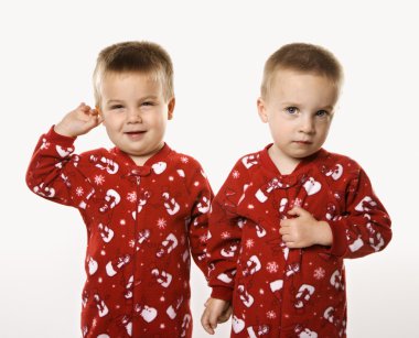 Twin boy brothers holding hands. clipart