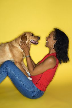 Woman playing with dog. clipart