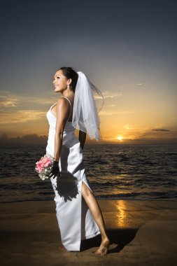 Beach Bride holding buket.