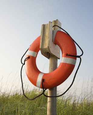 Life preserver hanging on post. clipart