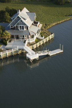 Coastal home with dock. clipart