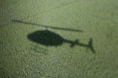 Helicopter shadow on marsh. clipart