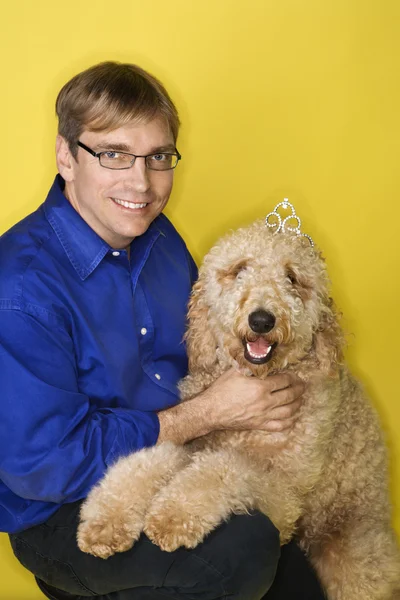 Caucasian man with Goldendoodle dog. — Stock Photo, Image