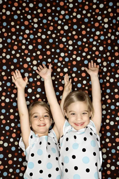 Girl twins with arms raised. — Stock Photo, Image