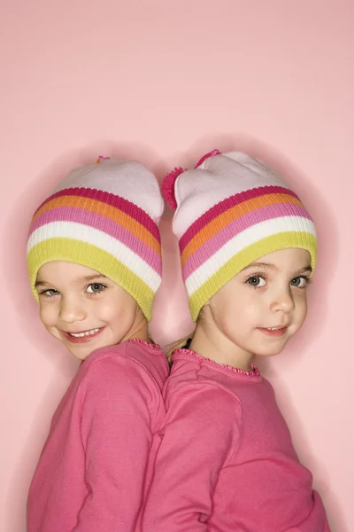 Girl twins back to back. — Stock Photo, Image