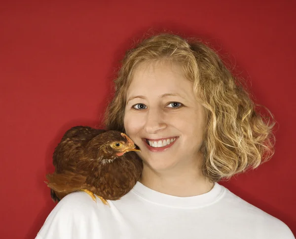 Woman with chicken on shoulder. — Stock Photo, Image