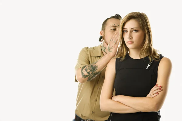 stock image Man whispering to teen girl.