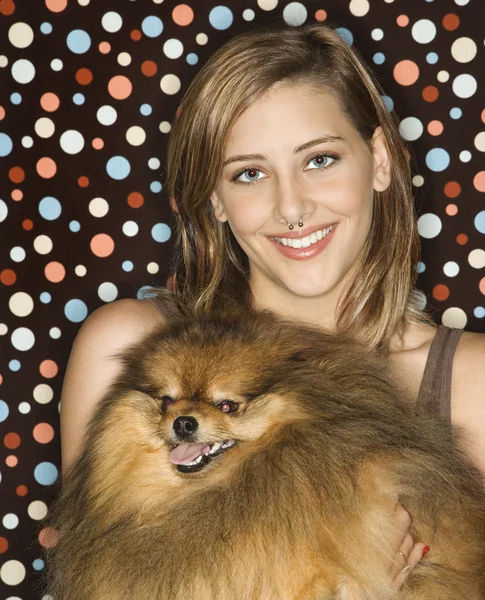 Teen girl holding Pomeranian dog. — Stock Photo, Image