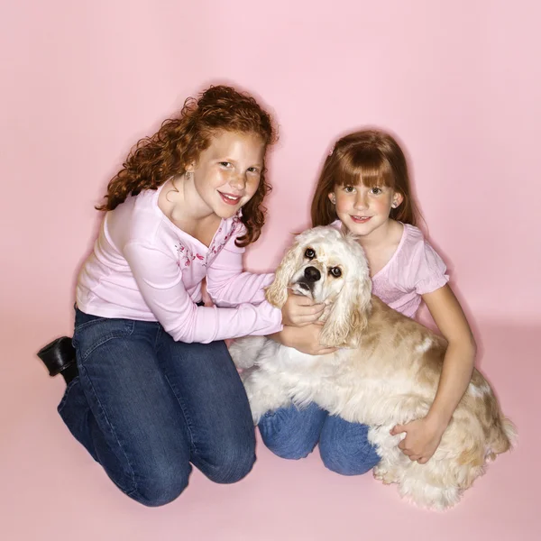 Girls holding Cocker Spaniel dog. — Stock Photo, Image