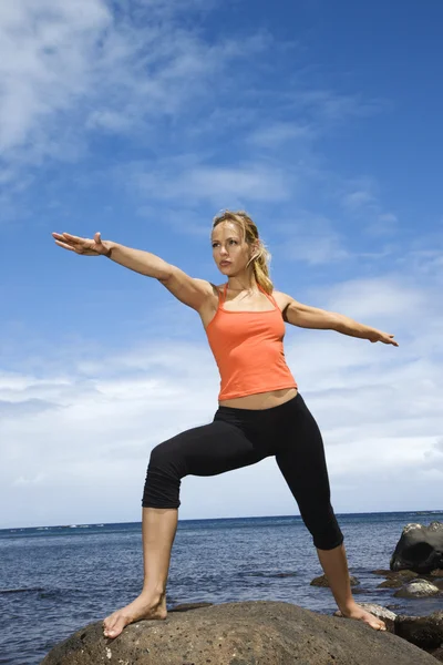 Woman doing yoga on shore. — Stock Photo, Image