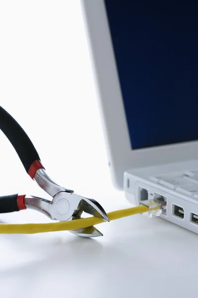 Wire Cutters Cutting Cable to Laptop — Stock Photo, Image